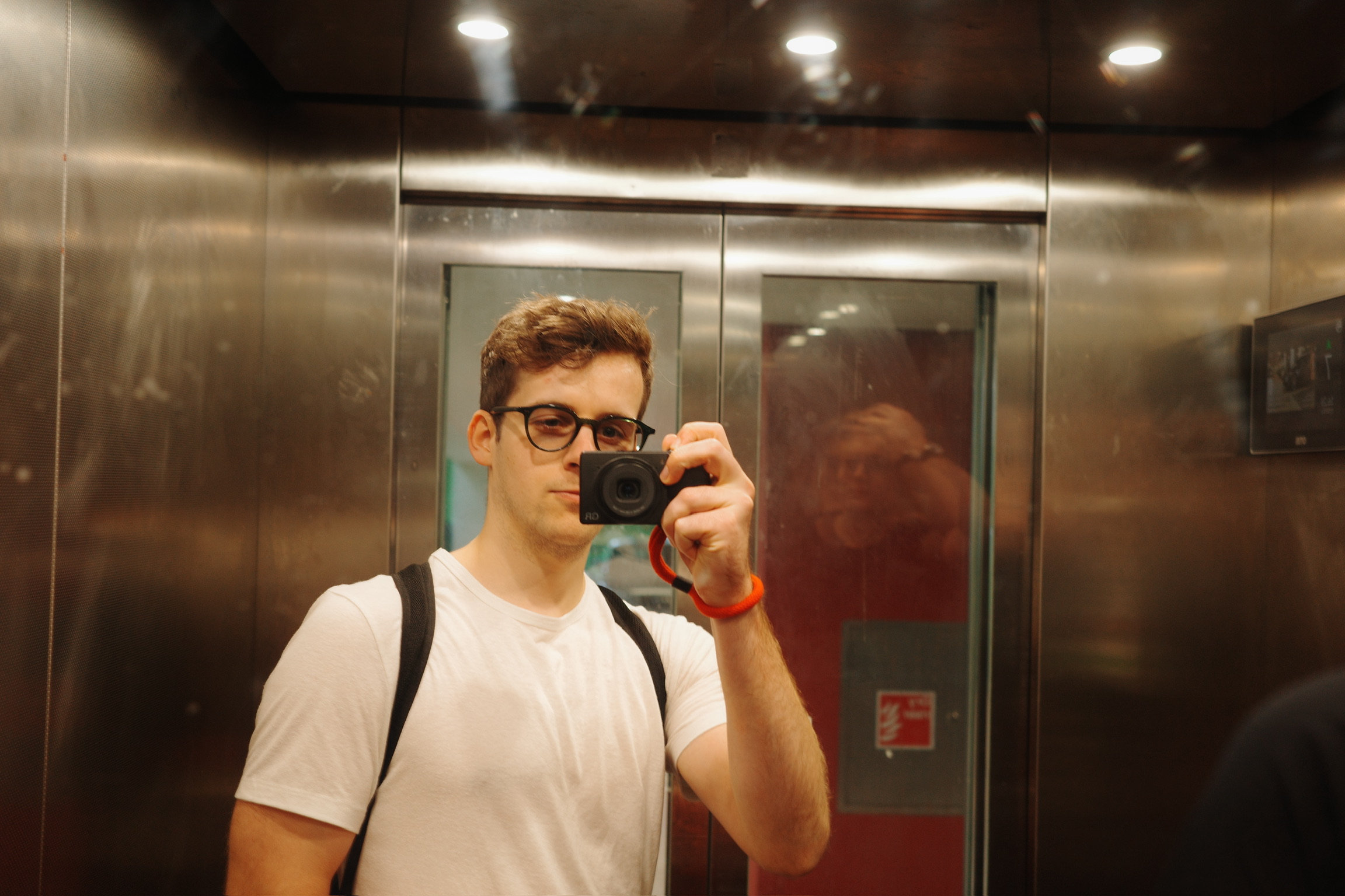 Empty flat with boxes stacked and beer bottles on the counter.